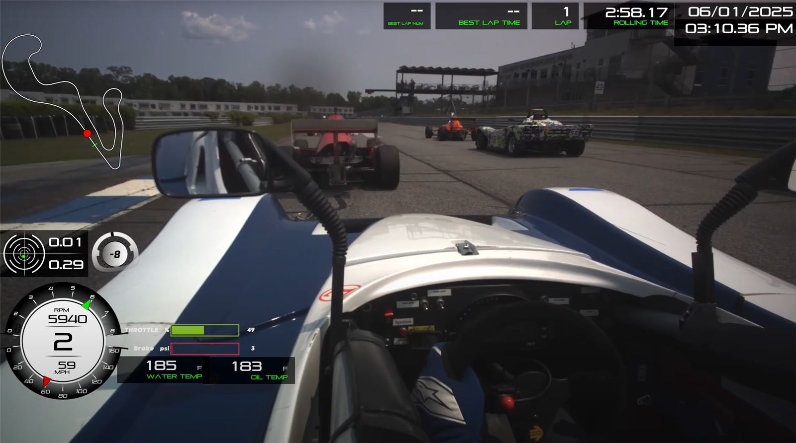 In-car view of a Spec Racer Ford following open-wheel cars at Atlanta Motorsports Park