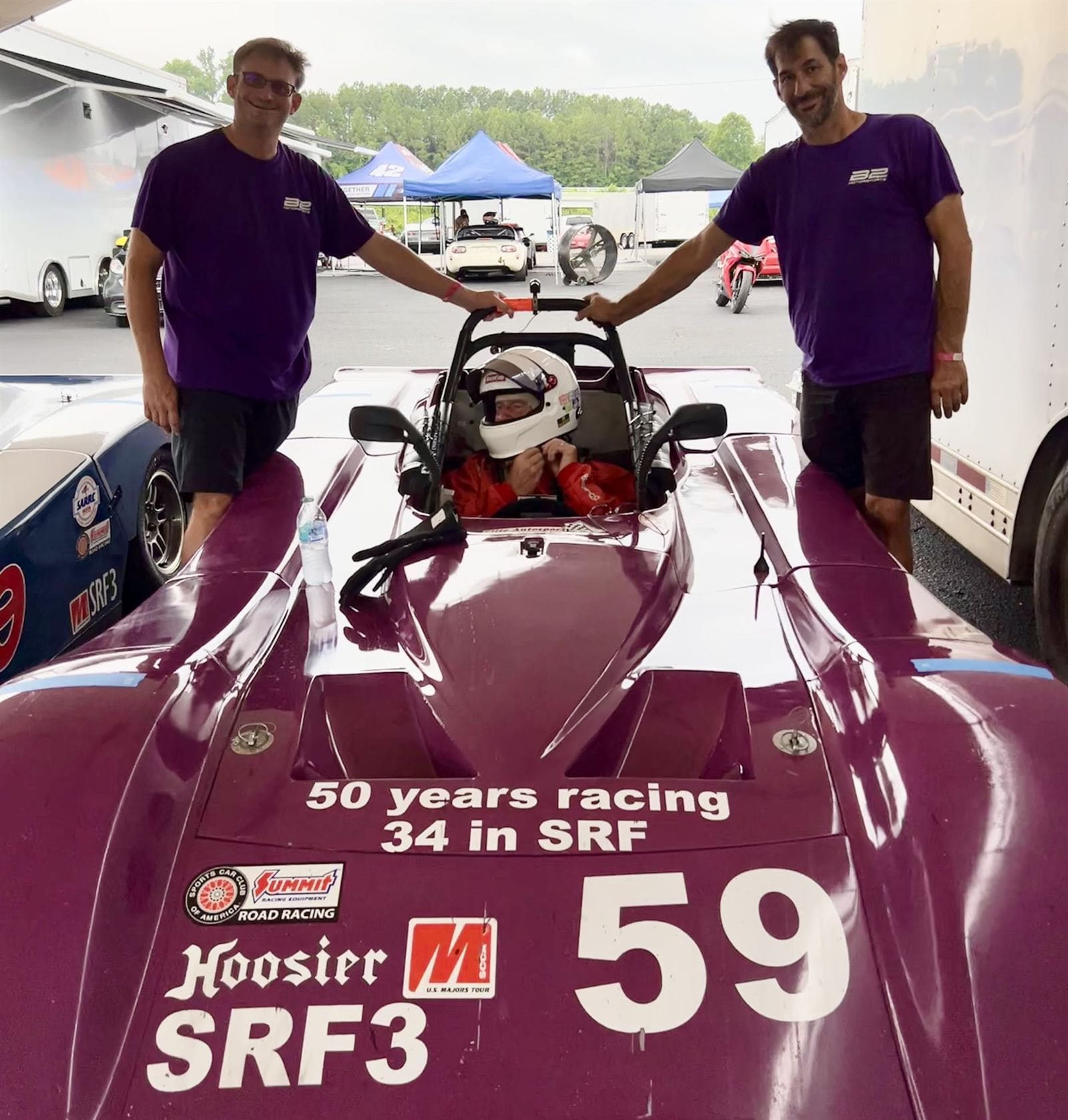 B2 Motorsports crew either side of Spec Racer Ford number 59 with the driver belted in