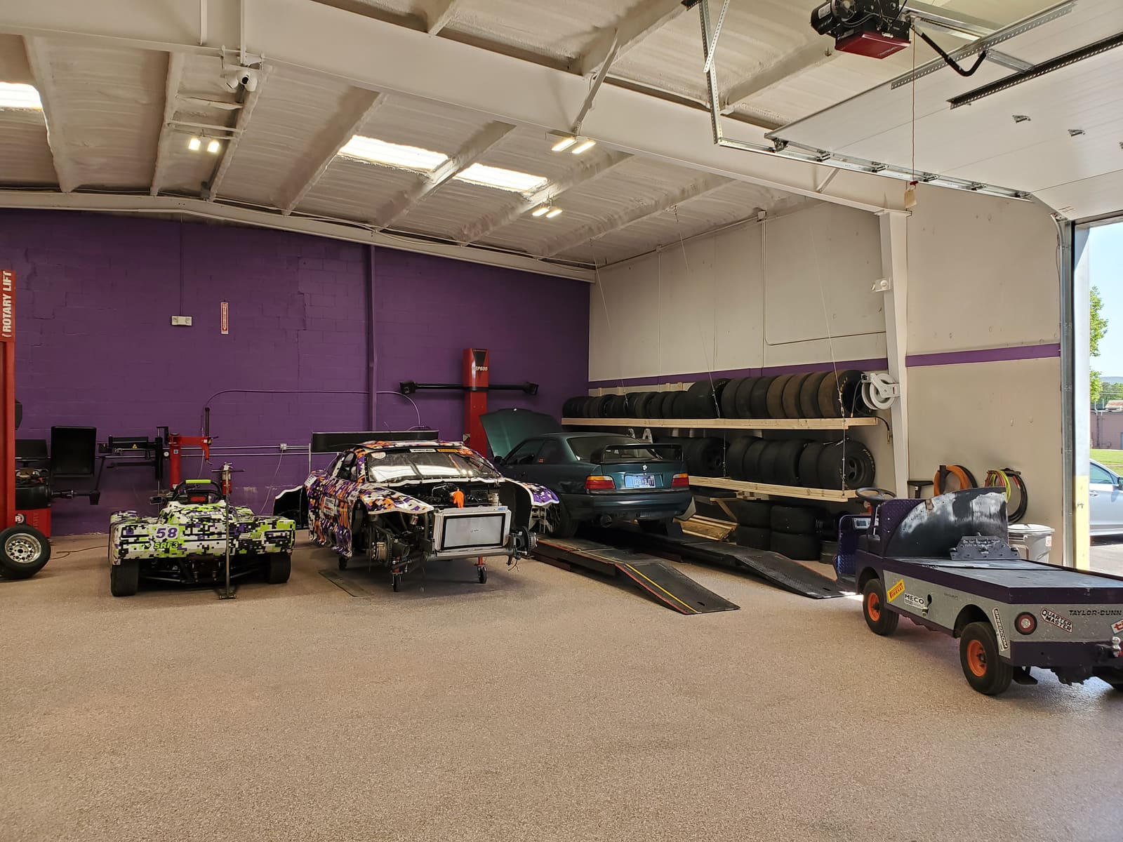 Members working in the B2 Motorsports DIY shop in Huntsville: two-post lift, tire rack and Spec Racer Fords