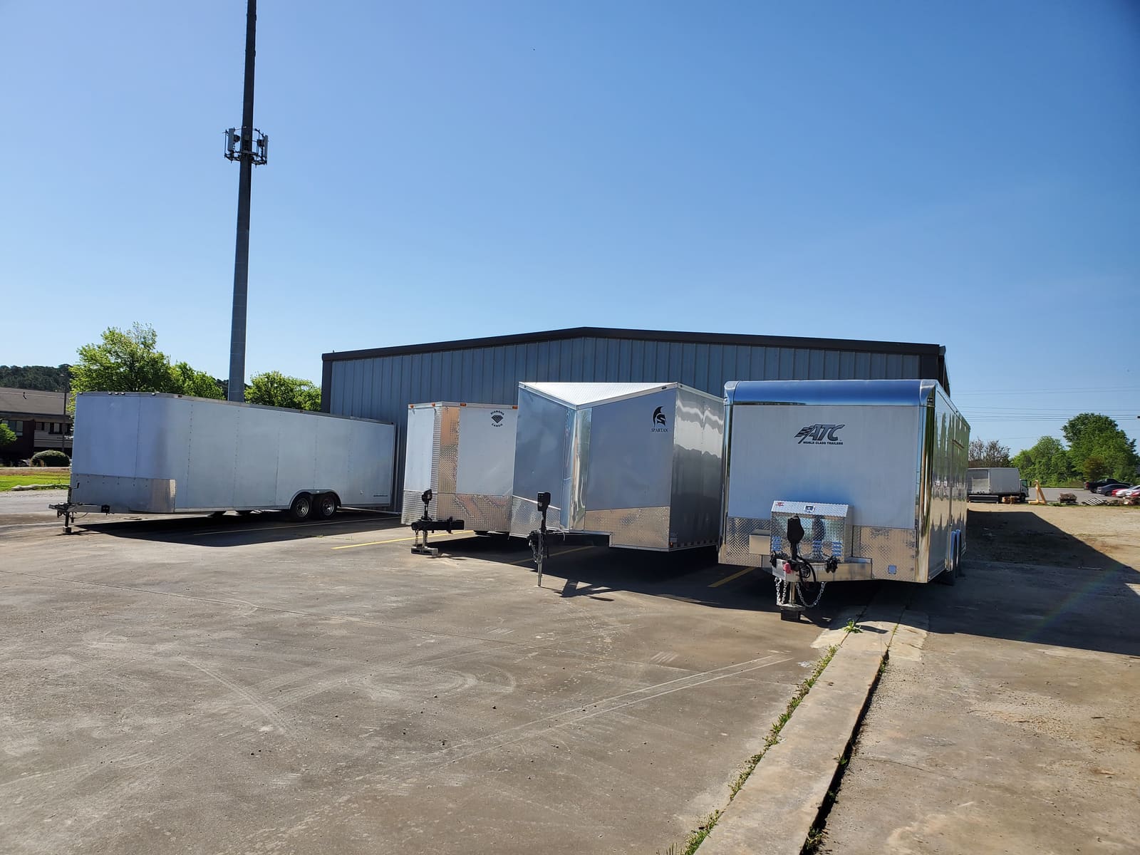 Enclosed cargo trailers lined up outside the B2 Motorsports building