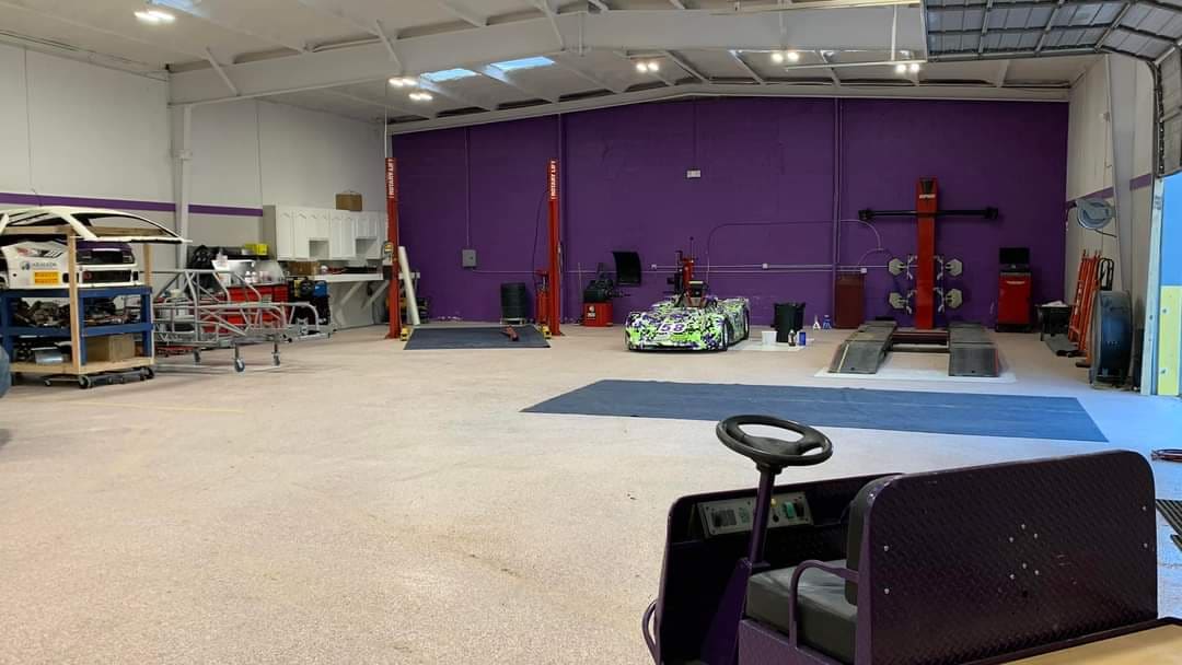 B2 Motorsports shop bay with purple wall and Spec Racer Ford car 58