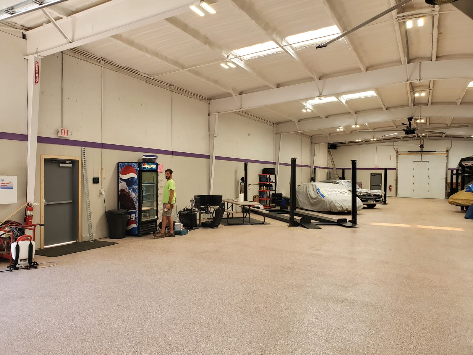 B2 Motorsports storage hall interior with a covered car on a lift