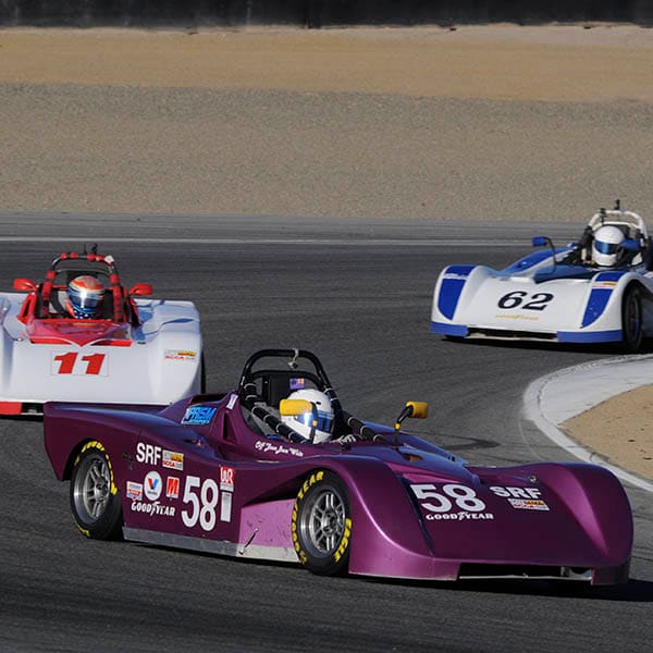 Three B2 Motorsports Spec Racer Fords mid-corner on a race weekend