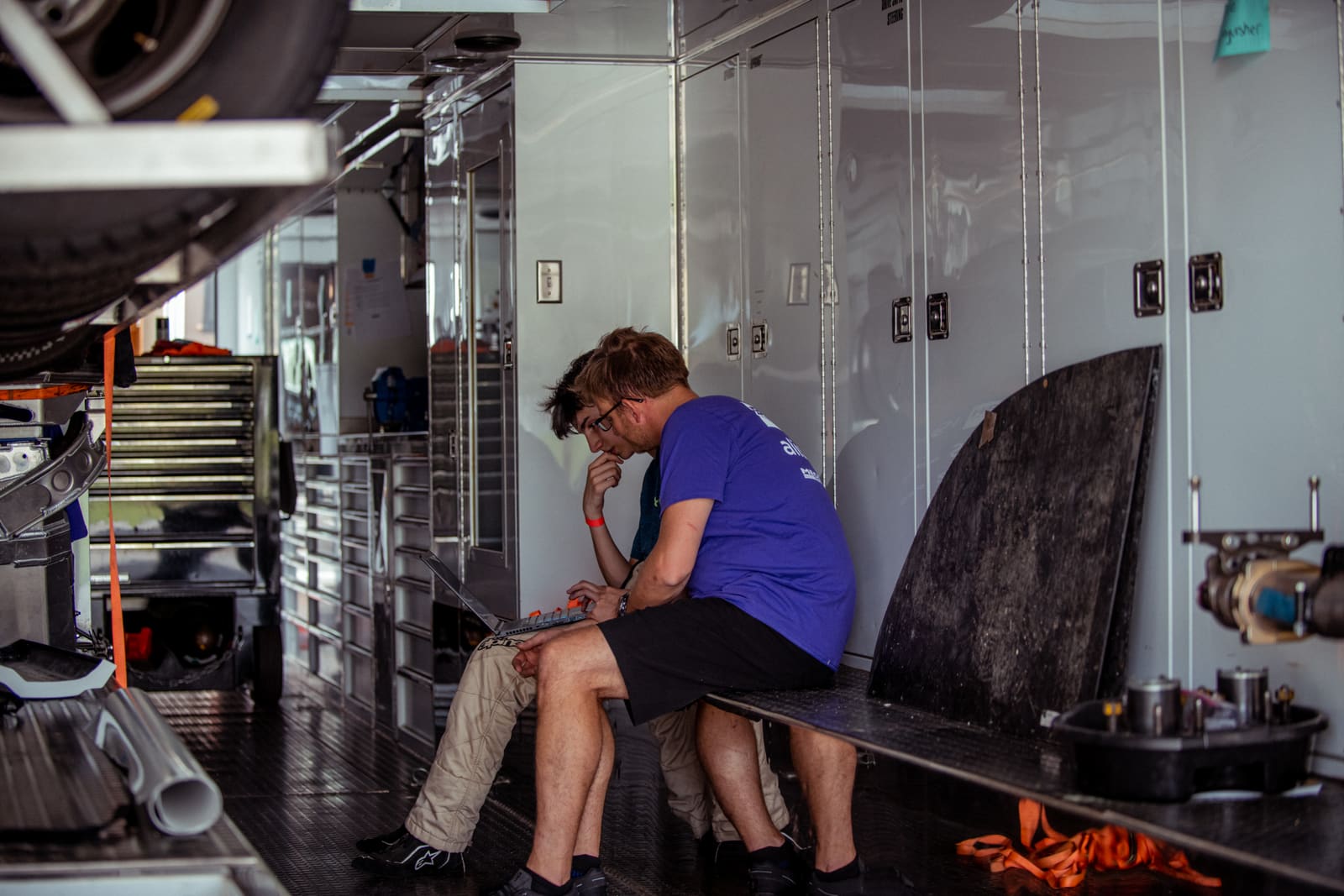 Cliff White reviewing lap data with a driver in the B2 Motorsports trailer at Polecat Training Center